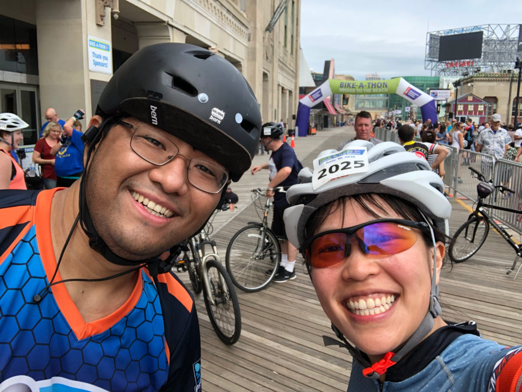 two cyclists on the boardwalk at the end of a long ride